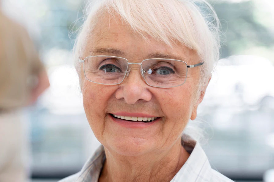 older woman in wireframe bifocals